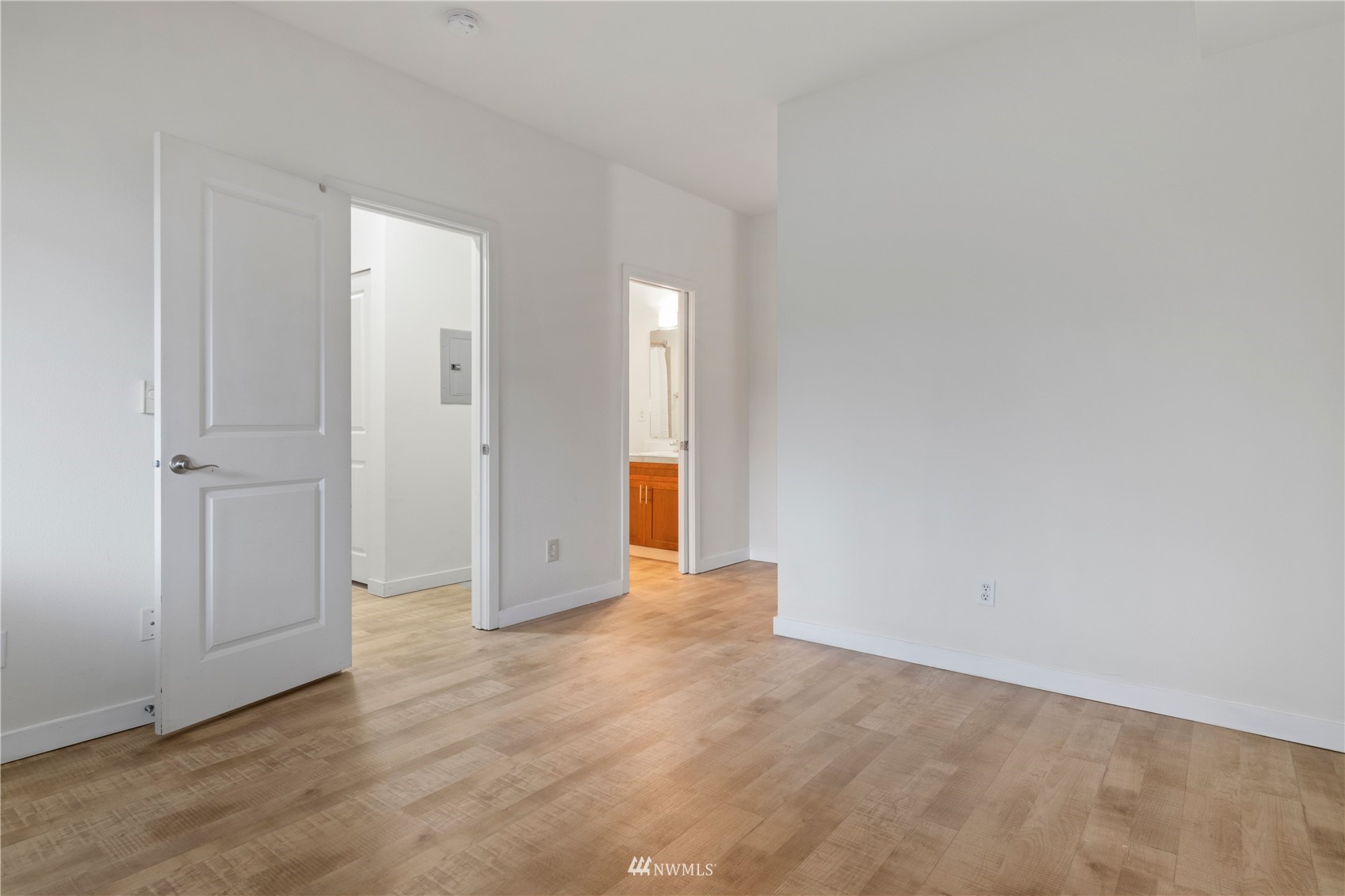 3901 243rd Place Southeast, Unit O102 Bothell, WA 98021 - Photo 21 of 32 an empty room with wooden floor and mirror