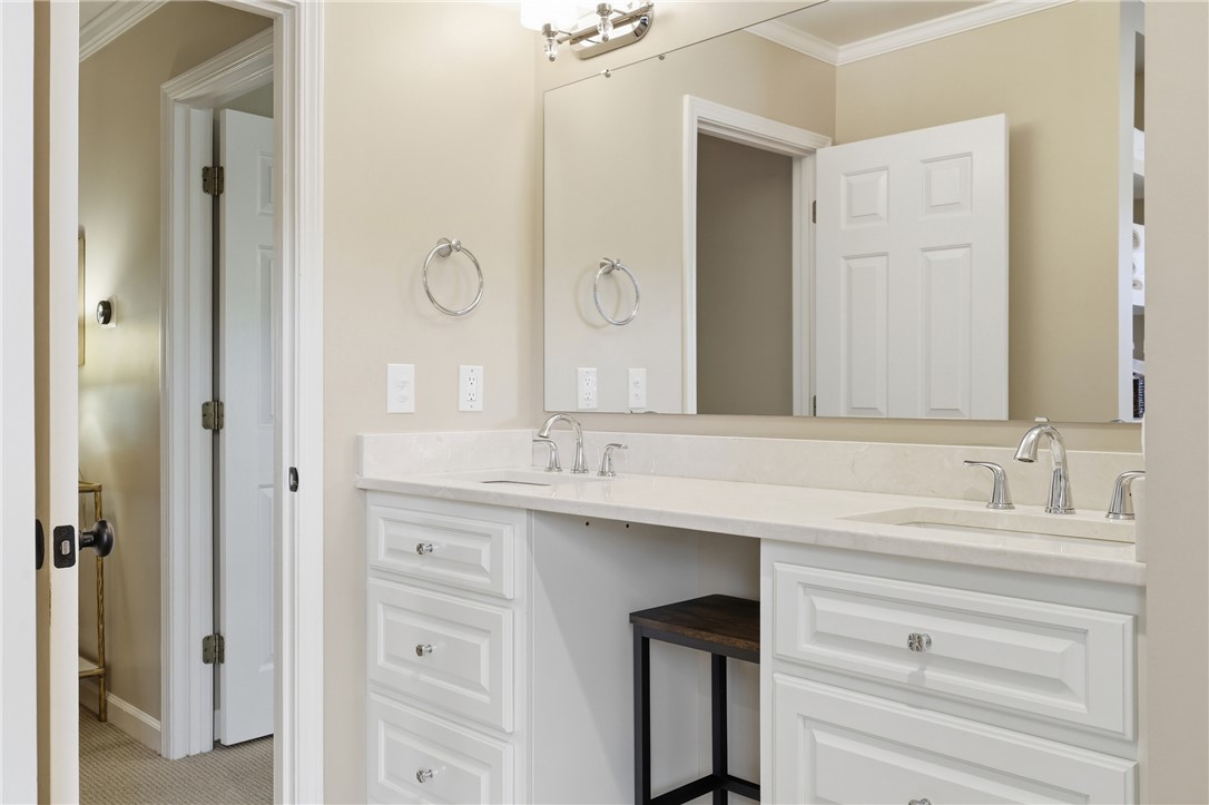 103 5 Knoll Court Anderson, SC 29621 - Photo 19 of 33 Gleaming stone counters and dual sinks define this elegant, well-lit primary bathroom vanity.