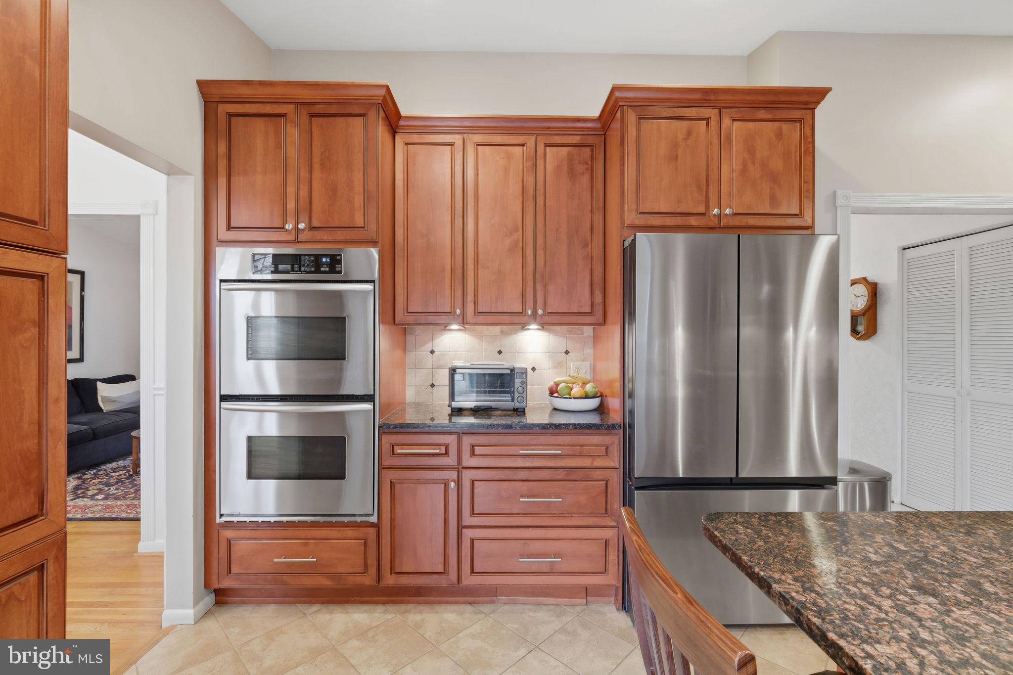8815 Postoak Road Potomac, MD 20854 - Photo 13 of 45 a kitchen with stainless steel appliances granite countertop a refrigerator and a stove