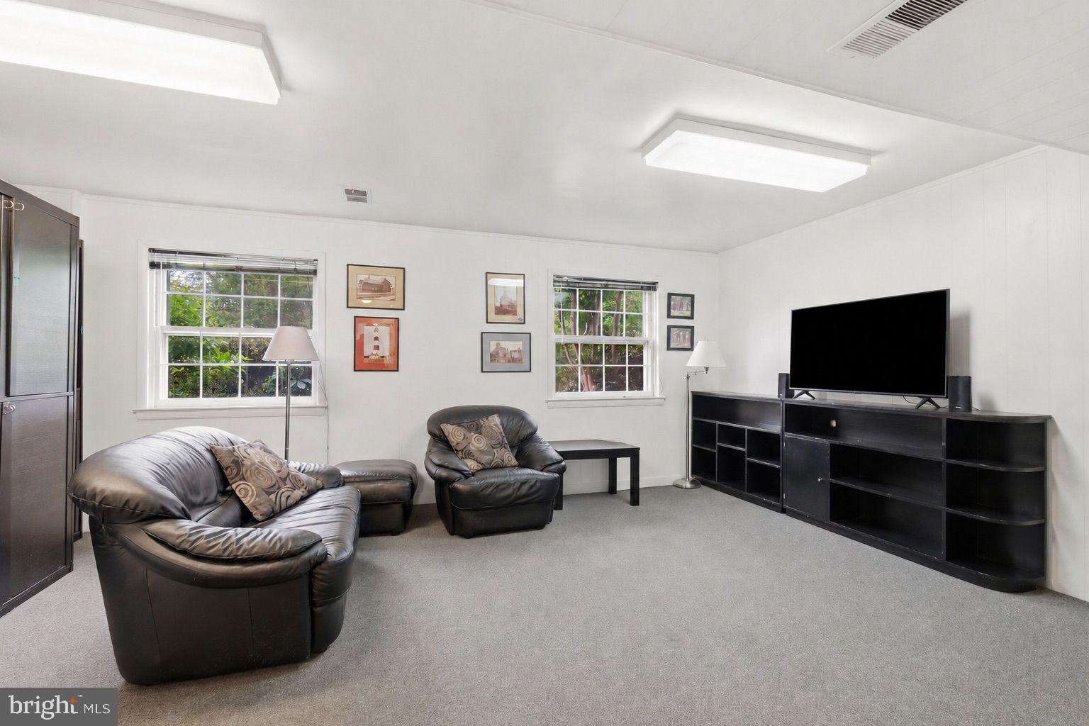 8815 Postoak Road Potomac, MD 20854 - Photo 20 of 45 a living room with furniture and a flat screen tv