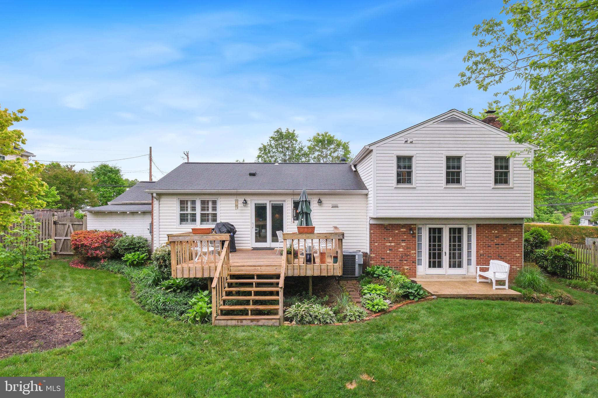 8815 Postoak Road Potomac, MD 20854 - Photo 2 of 45 a front view of a house with a garden and porch