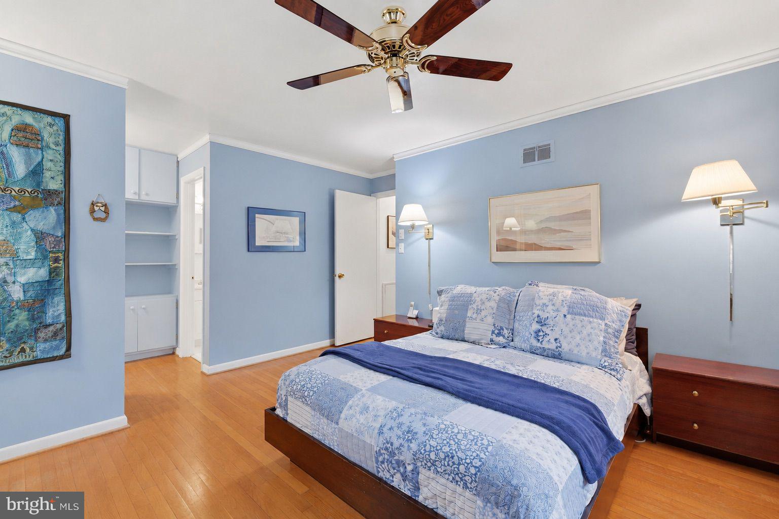 8815 Postoak Road Potomac, MD 20854 - Photo 24 of 45 a bedroom with a large bed and a chandelier