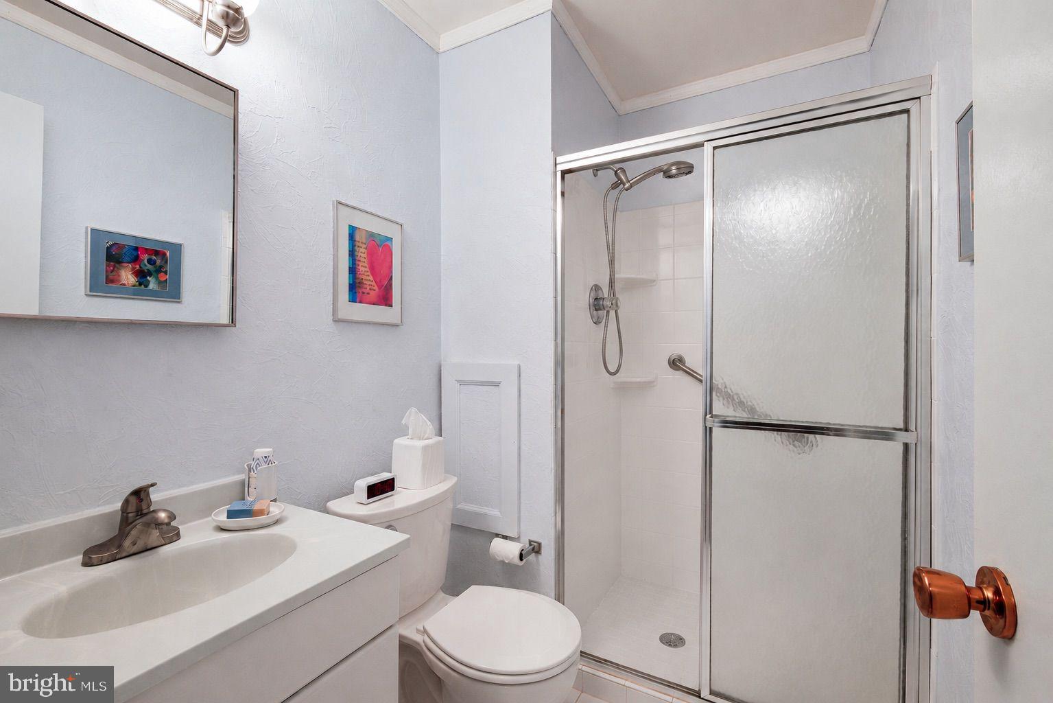 8815 Postoak Road Potomac, MD 20854 - Photo 26 of 45 a bathroom with a sink toilet and shower