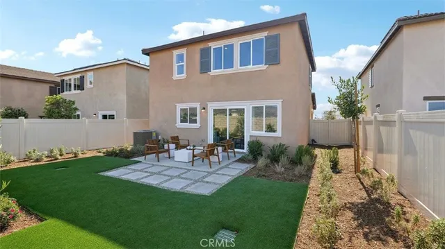 a backyard of a house with table and chairs