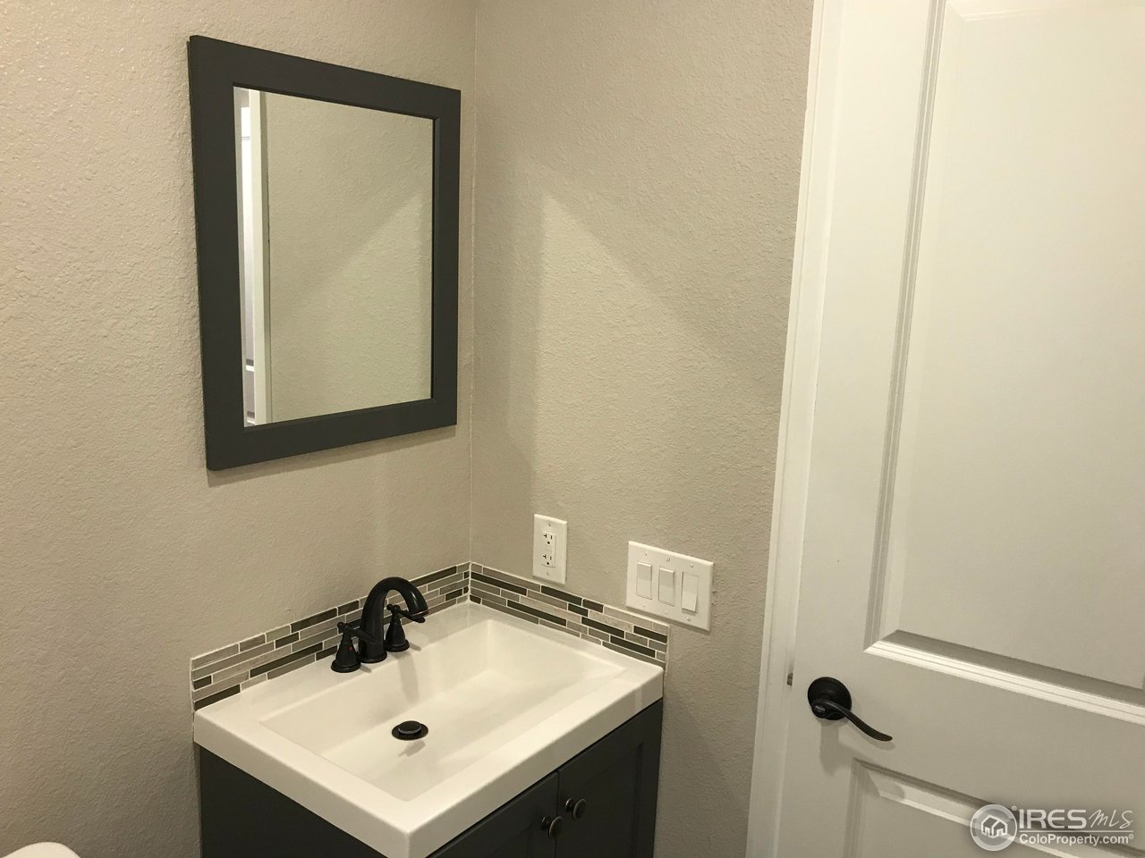 1065 Modred Street Lafayette, CO 80026 - Photo 12 of 23 a bathroom with a sink and a mirror