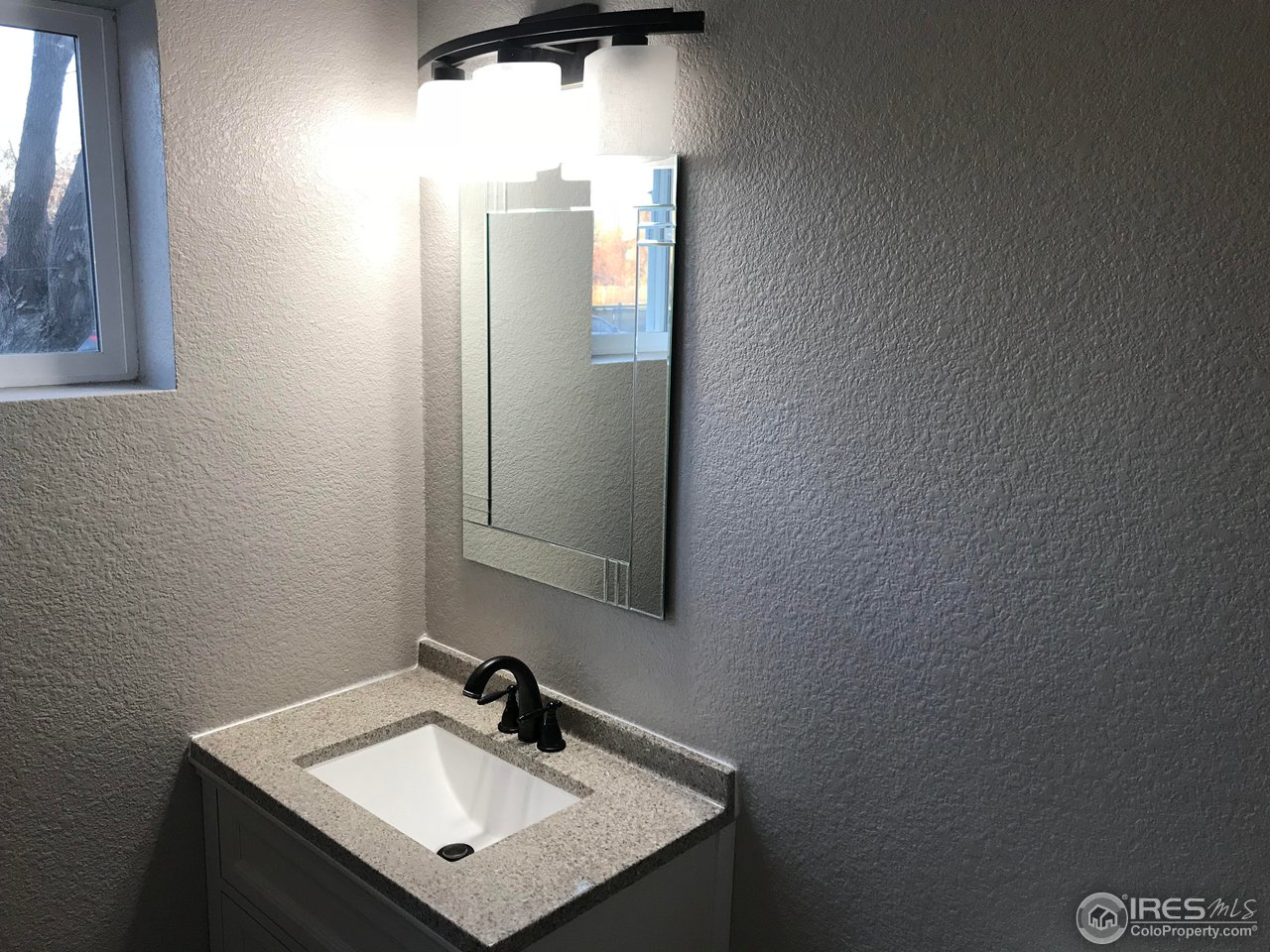 1065 Modred Street Lafayette, CO 80026 - Photo 13 of 23 a bathroom with a sink and a mirror