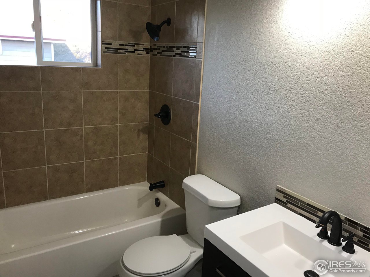 1065 Modred Street Lafayette, CO 80026 - Photo 14 of 23 a bathroom with a sink toilet and shower