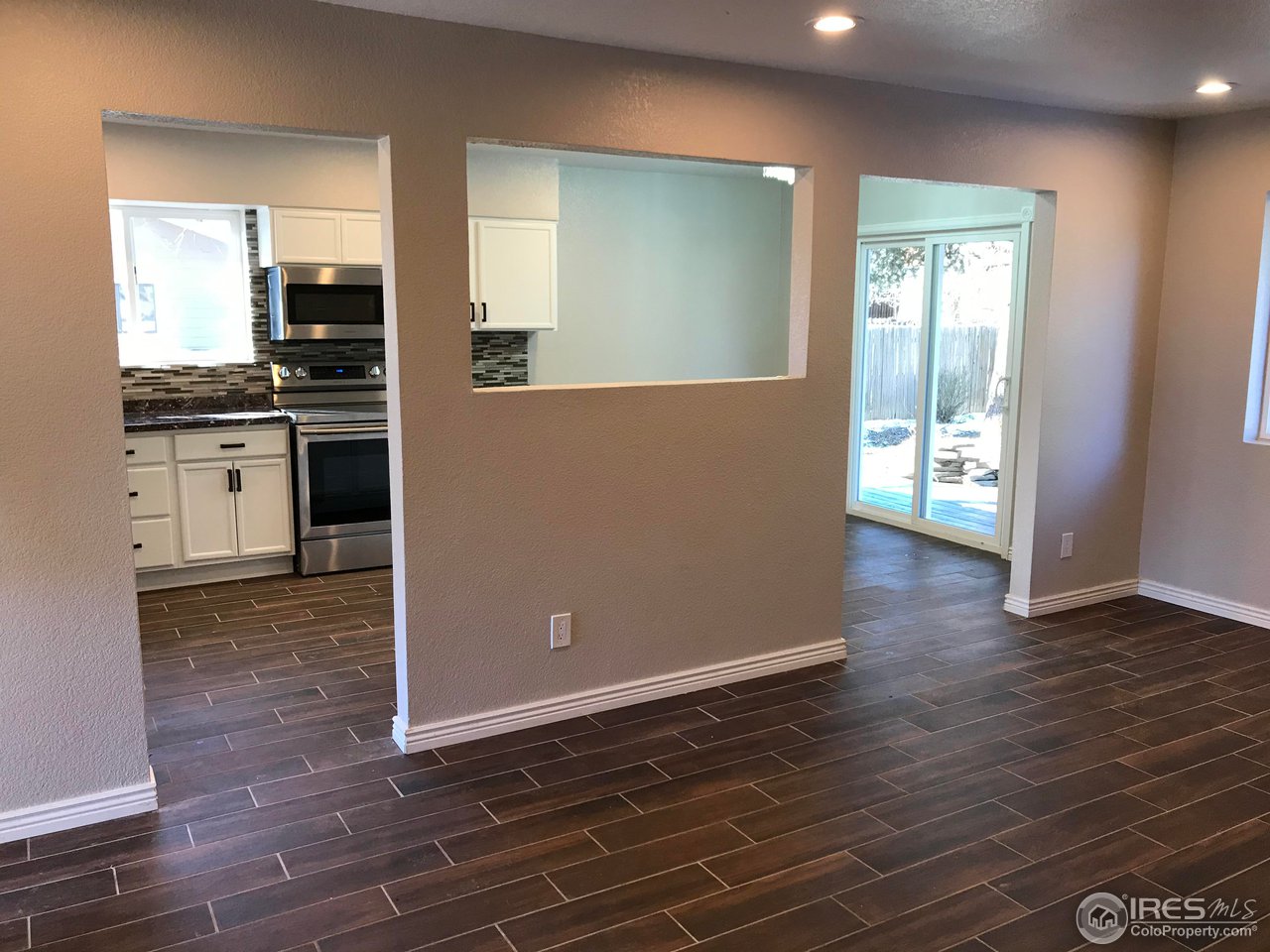 1065 Modred Street Lafayette, CO 80026 - Photo 17 of 23 a view of kitchen with cabinets and wooden floor