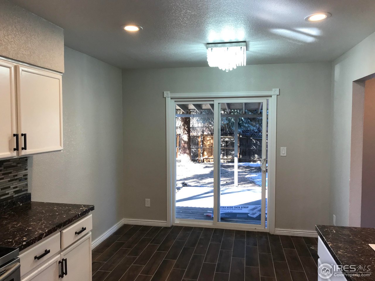 1065 Modred Street Lafayette, CO 80026 - Photo 3 of 23 a view of wooden floor and a chandelier in a kitchen
