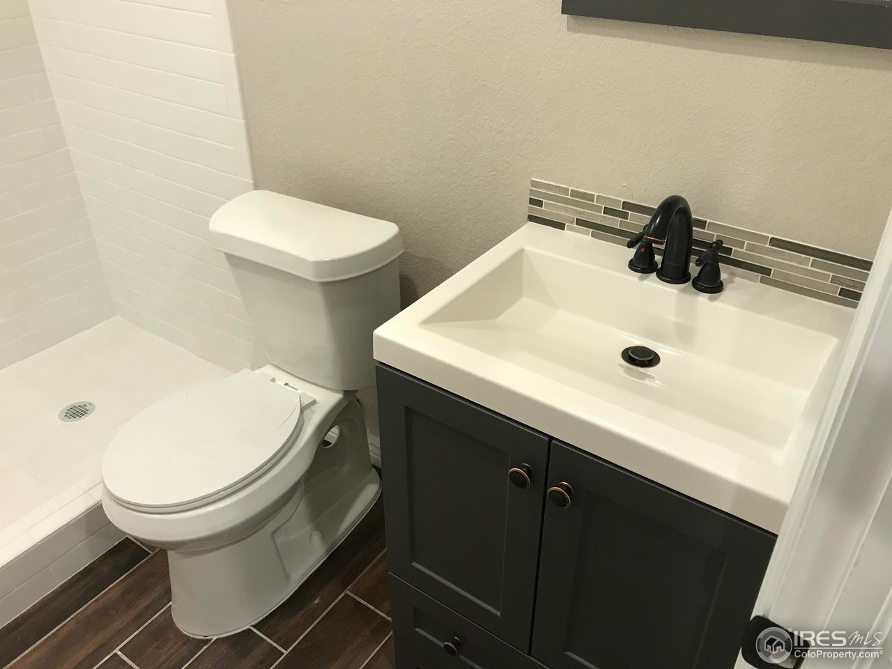 1065 Modred Street Lafayette, CO 80026 - Photo 10 of 23 a bathroom with a sink toilet and mirror