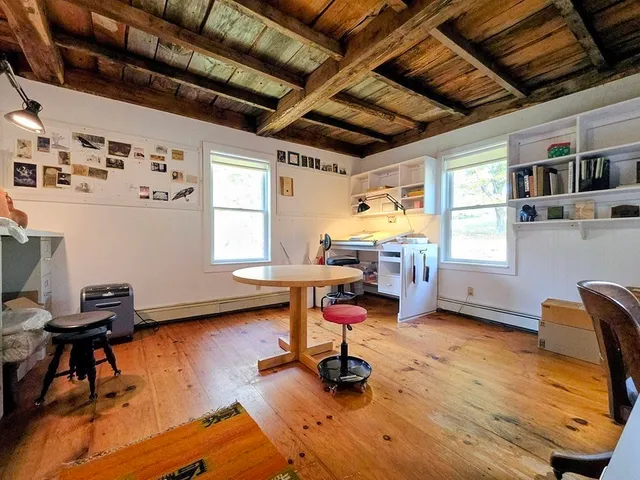 a livingroom with workspace and a window