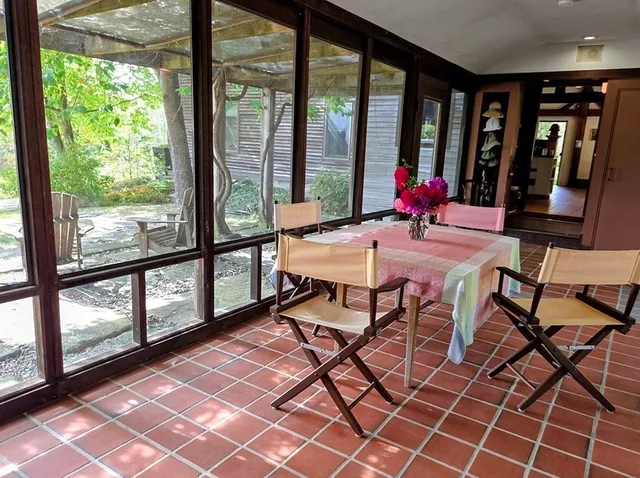 a view of a room with wooden floor and windows