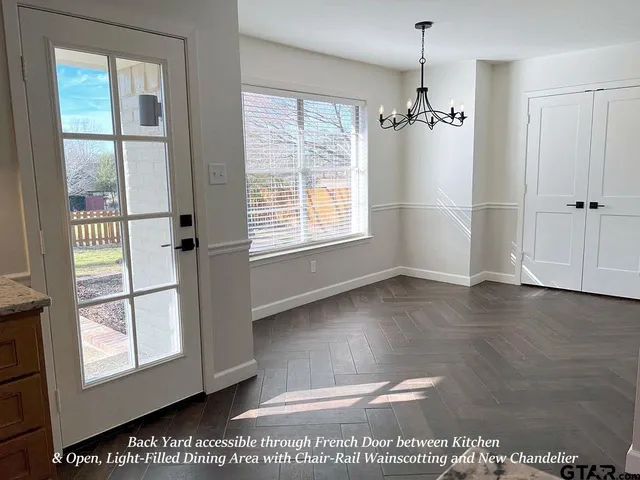 a view of an entryway with wooden floor