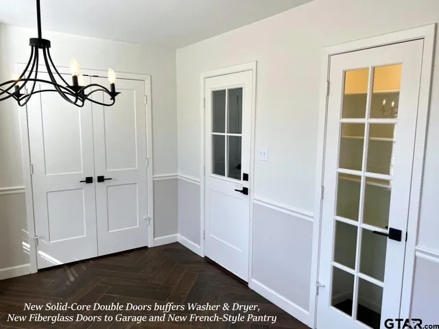 an empty room with a window and a ceiling fan
