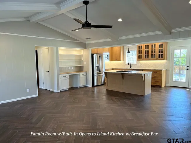 a view of a kitchen with a sink and wooden floor