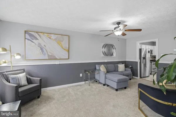 a living room with furniture and a chandelier