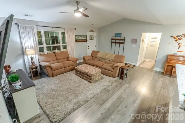 a living room with furniture window and a flat screen tv