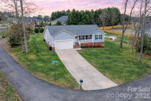 a aerial view of a house next to a big yard