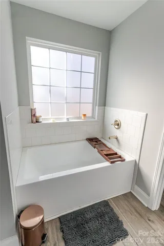 a bathroom with a window and a bathtub