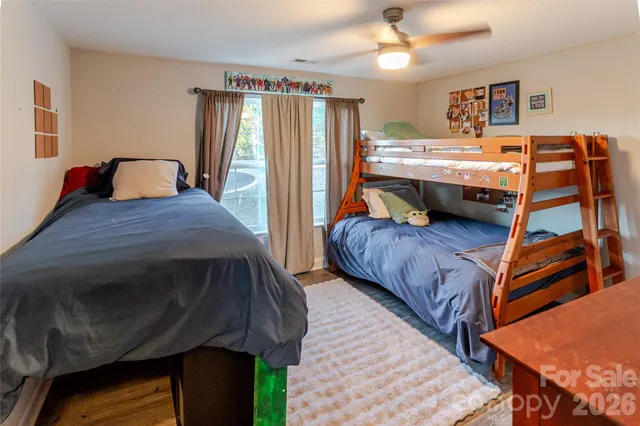 a bedroom with a bed next to a window