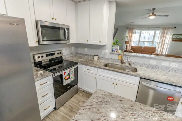 a kitchen with a sink stove and microwave