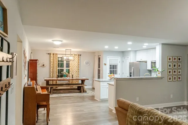 a living room with furniture and a kitchen