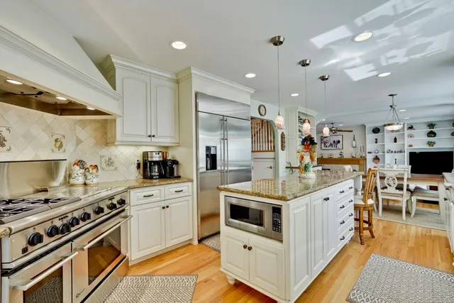 a kitchen with stainless steel appliances a stove a sink dishwasher and a refrigerator