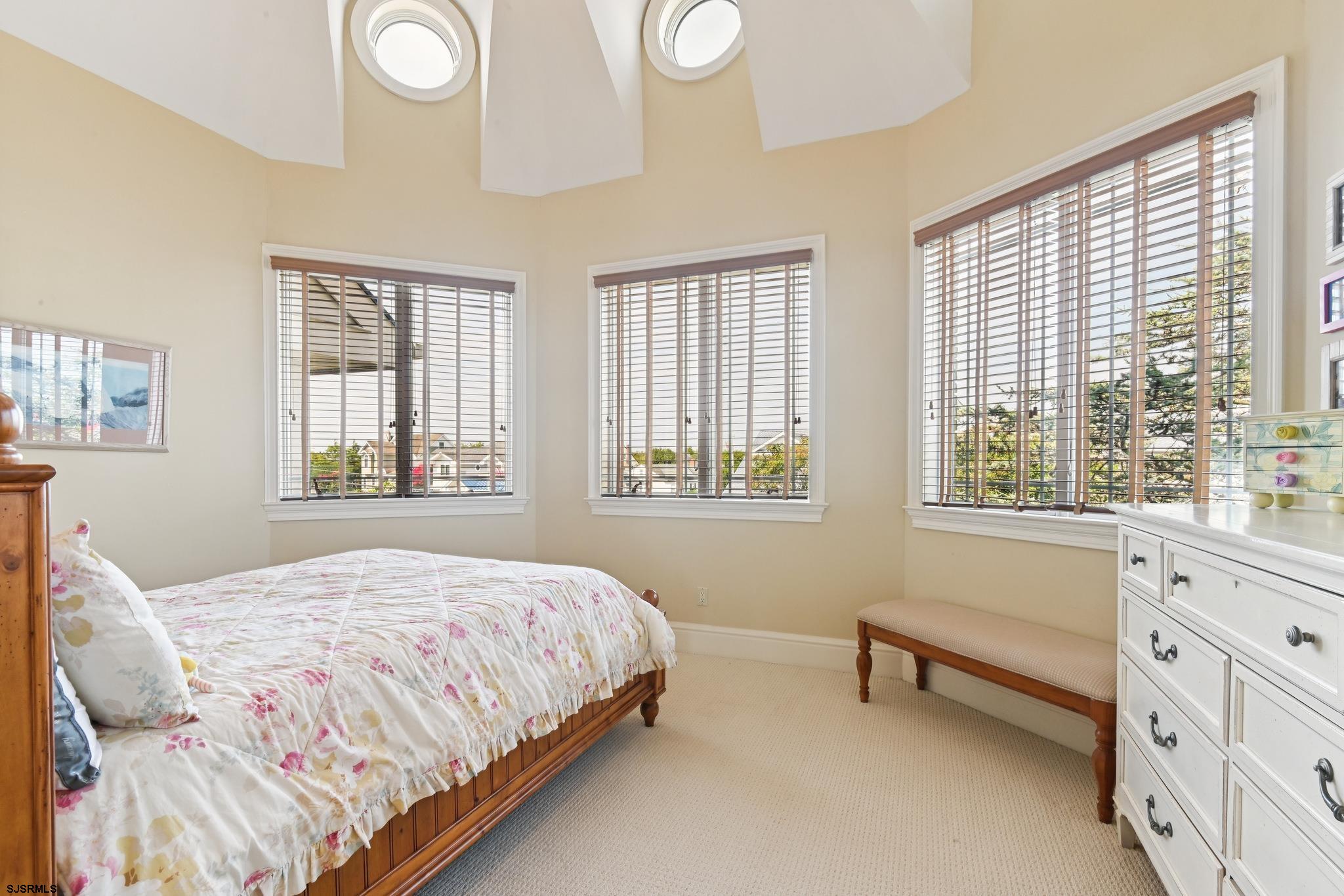 301 Wesley Road Ocean City, NJ 08226 - Photo 14 of 44 a bedroom with a bed and a window