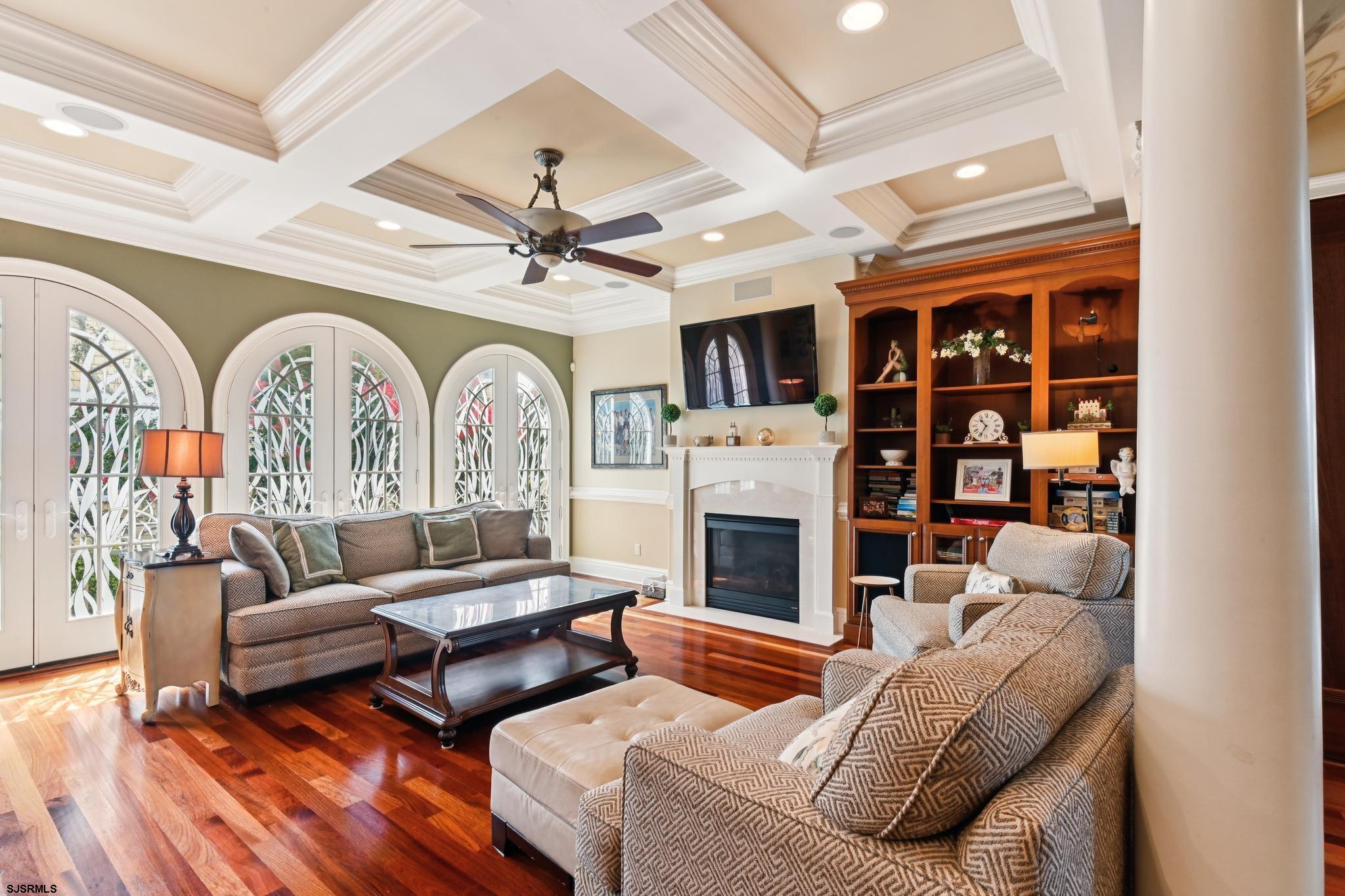 301 Wesley Road Ocean City, NJ 08226 - Photo 6 of 44 a living room with furniture a fireplace and a chandelier