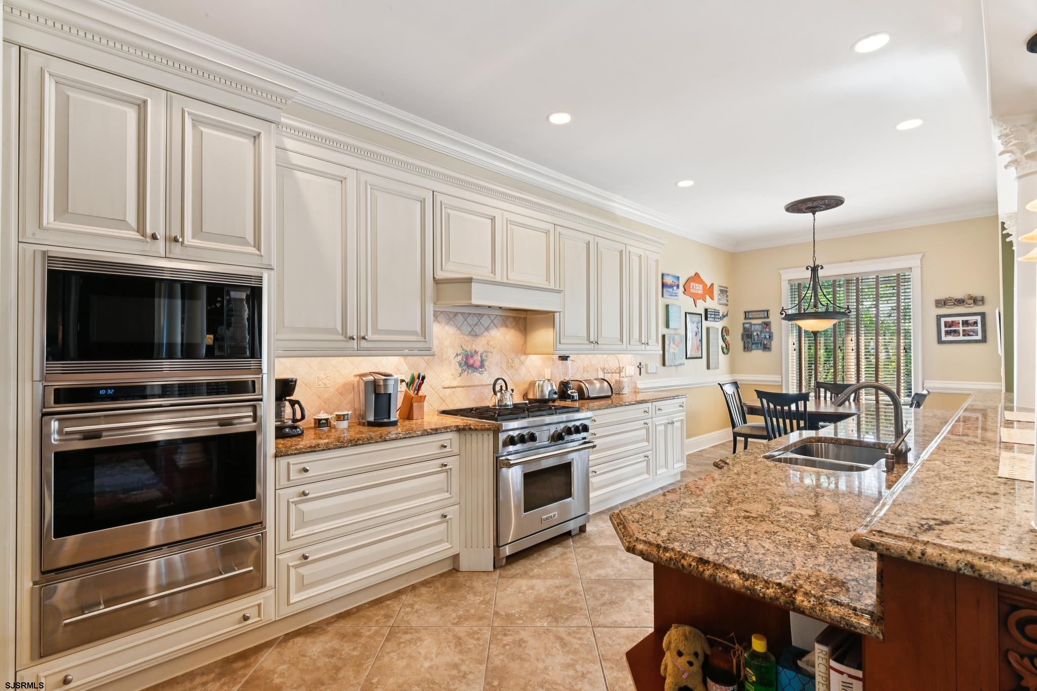 301 Wesley Road Ocean City, NJ 08226 - Photo 8 of 44 a kitchen with granite countertop kitchen island stainless steel appliances a stove sink and cabinets