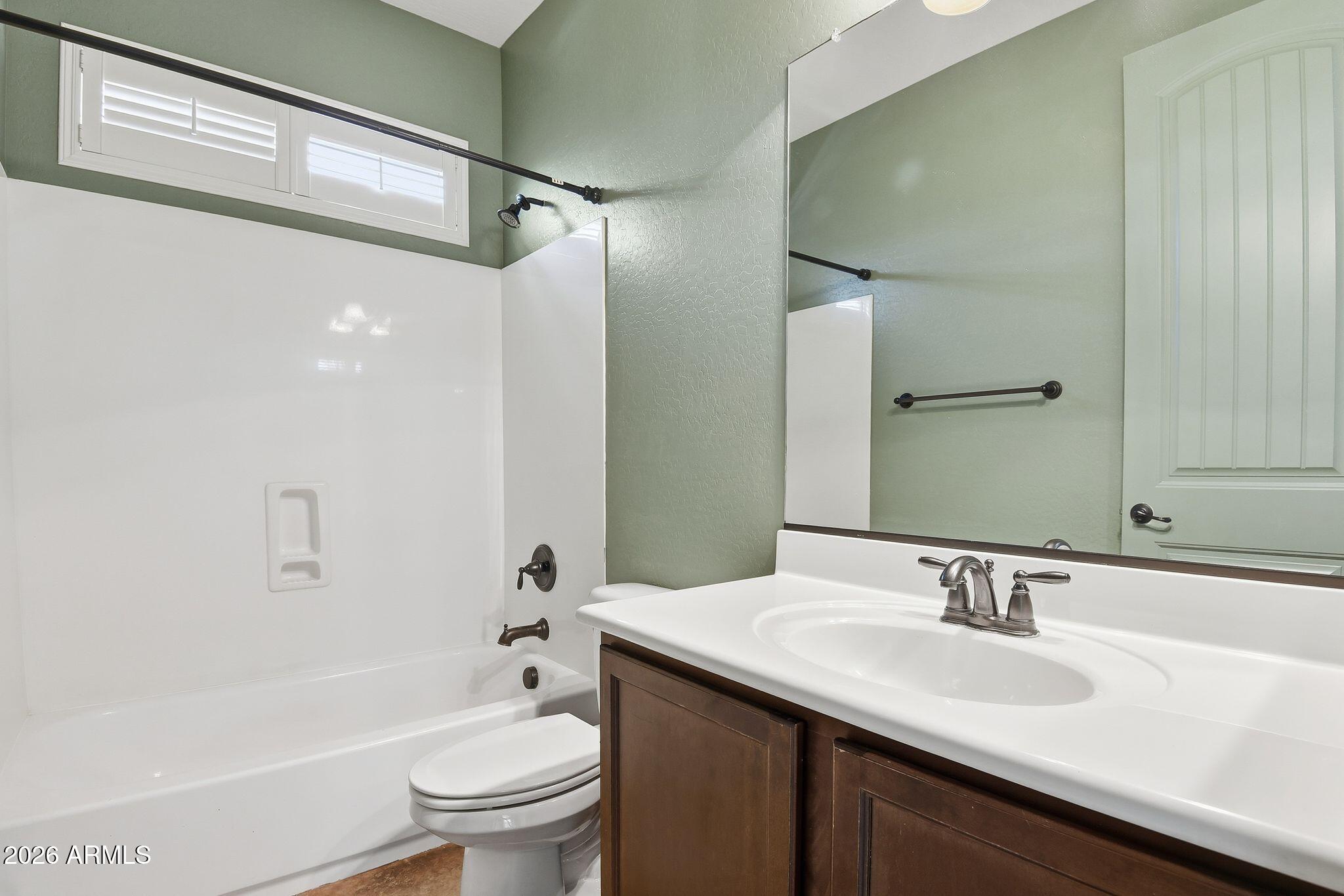 3484 East Mesquite Street Gilbert, AZ 85296 - Photo 14 of 16 a bathroom with a granite countertop sink toilet and shower