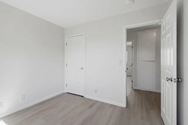 a view of a room with wooden floor