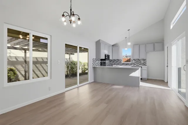 a view of a kitchen with a sink a refrigerator and window