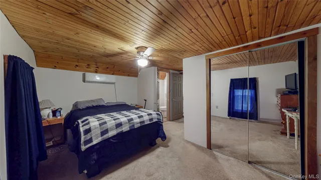 a bedroom with a bed and a mirror