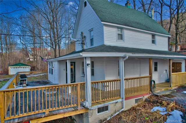 a view of a brick house with a small yard