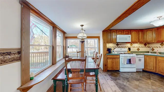 a kitchen with stainless steel appliances granite countertop sink stove top oven and cabinets