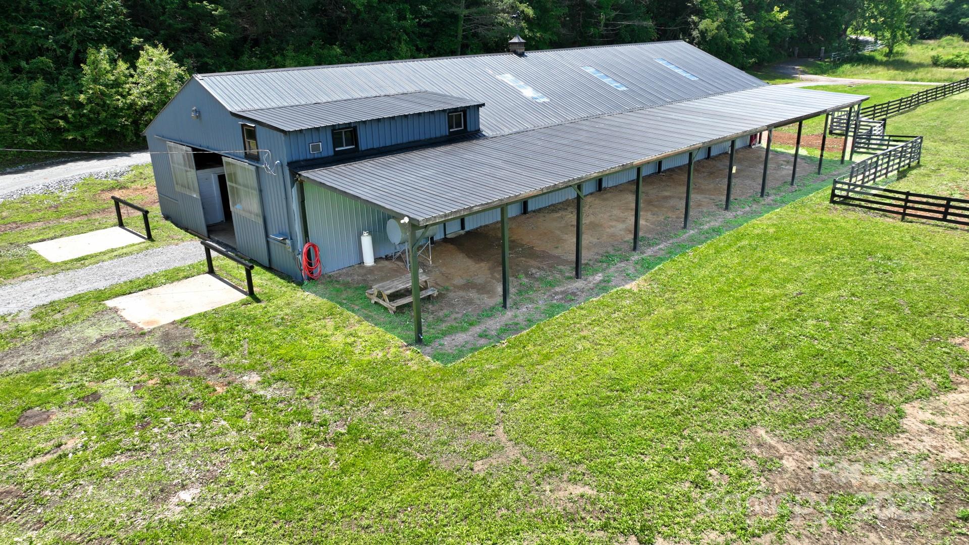 an aerial view of a house with swimming pool and porch with furniture