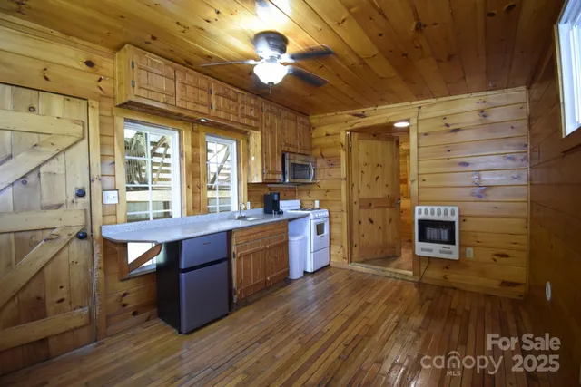 a kitchen with stainless steel appliances kitchen island granite countertop a stove a sink and a microwave