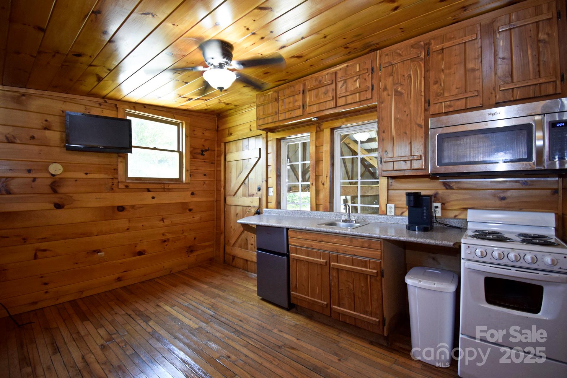 2941 Roby Martin Road Lenoir, NC 28645 - Photo 23 of 47 a kitchen with a stove a sink and wooden floor