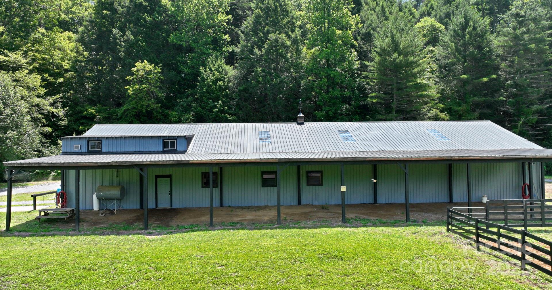 2941 Roby Martin Road Lenoir, NC 28645 - Photo 6 of 47 a backyard of a house with lawn chairs and a large tree