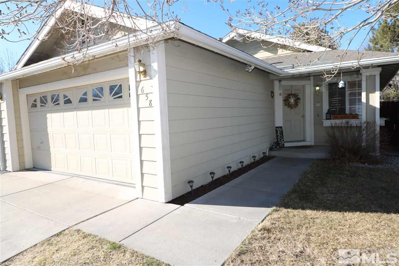 7658 Devonshire Lane Reno, NV 89511 - Photo 1 of 16 a view of a house with a wooden bench