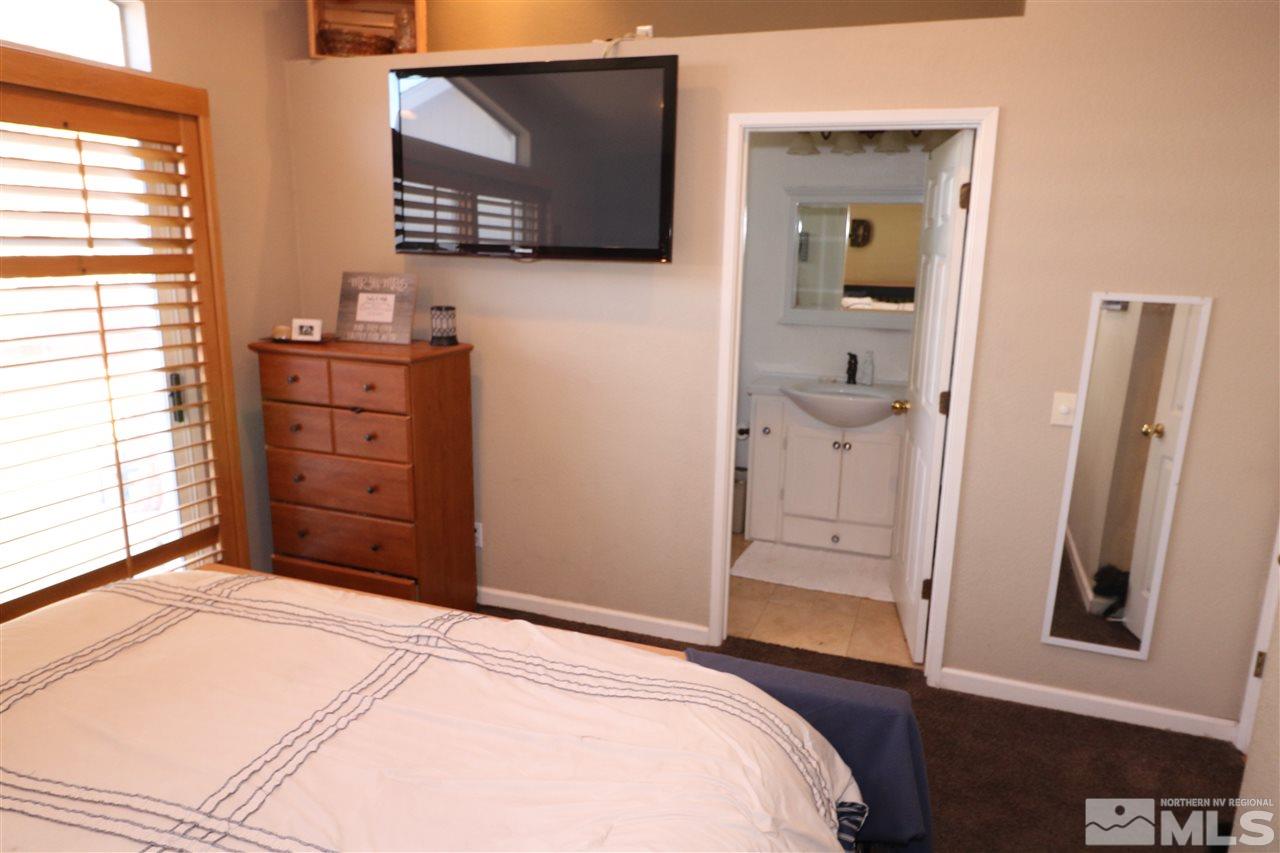 7658 Devonshire Lane Reno, NV 89511 - Photo 11 of 16 a bedroom with a bed and a television