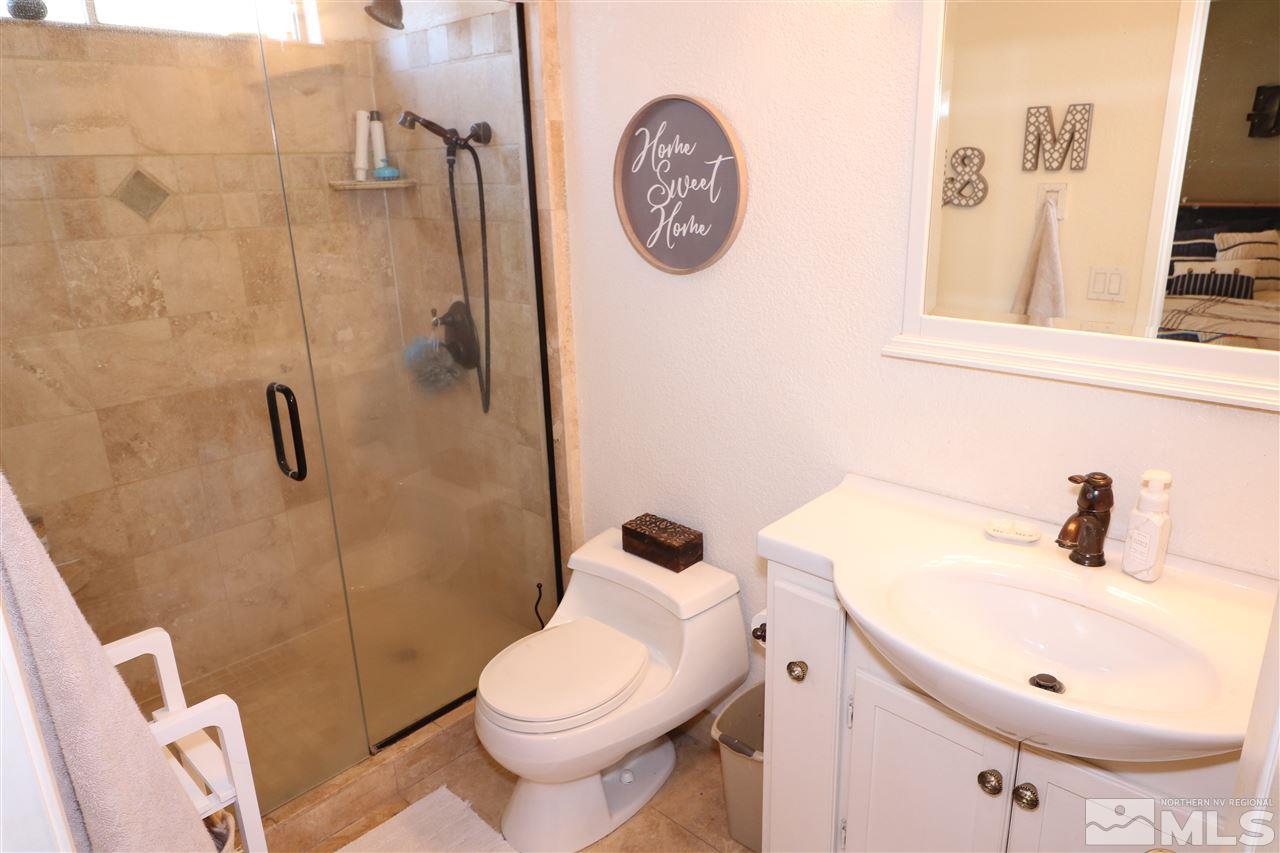 7658 Devonshire Lane Reno, NV 89511 - Photo 12 of 16 a bathroom with a toilet and a sink
