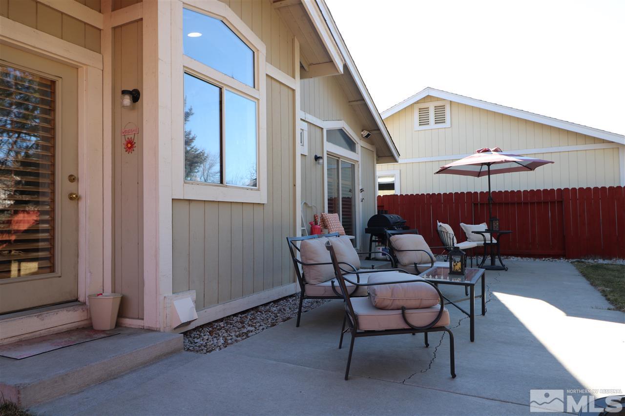 7658 Devonshire Lane Reno, NV 89511 - Photo 14 of 16 an outdoor space with patio couches and a fireplace