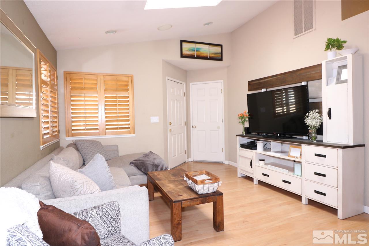 7658 Devonshire Lane Reno, NV 89511 - Photo 2 of 16 a living room with furniture and a flat screen tv