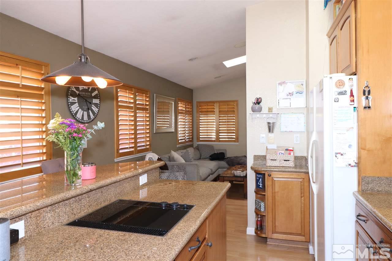 7658 Devonshire Lane Reno, NV 89511 - Photo 5 of 16 a kitchen with stainless steel appliances granite countertop a sink and a stove