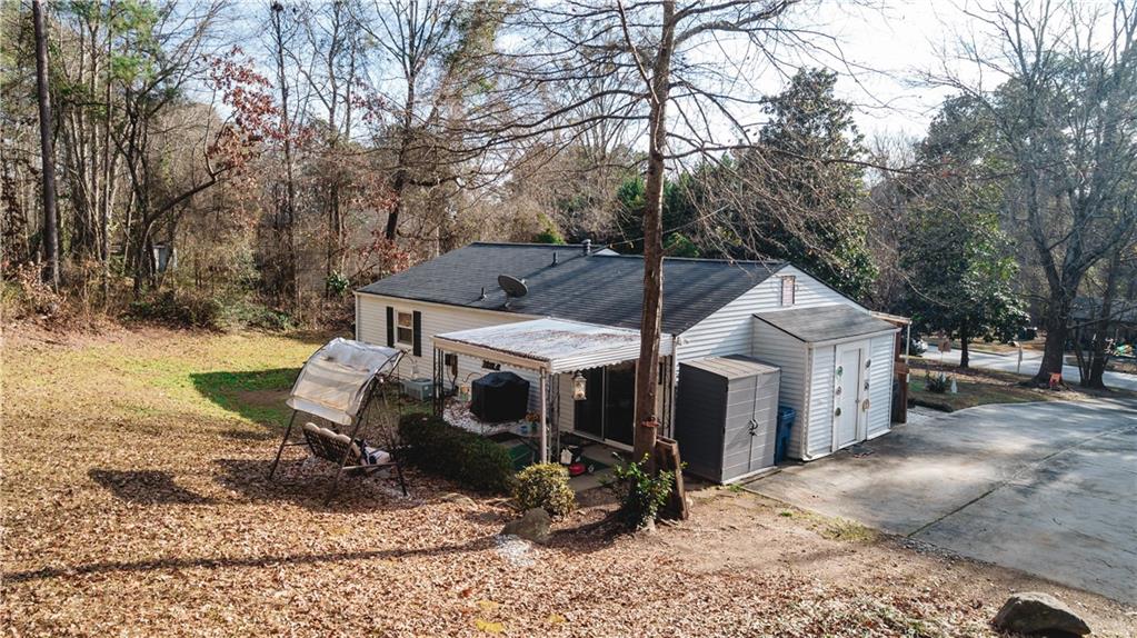 3184 Newcastle Way Snellville, GA 30039 - Photo 14 of 36 a view of a patio with a table and chairs under an umbrella
