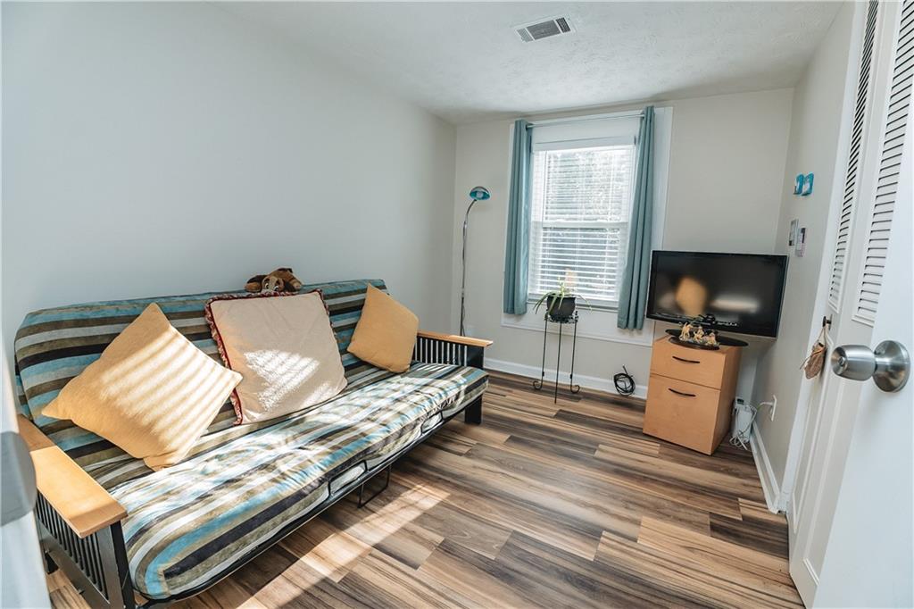 3184 Newcastle Way Snellville, GA 30039 - Photo 19 of 36 a bedroom with furniture and a flat screen tv