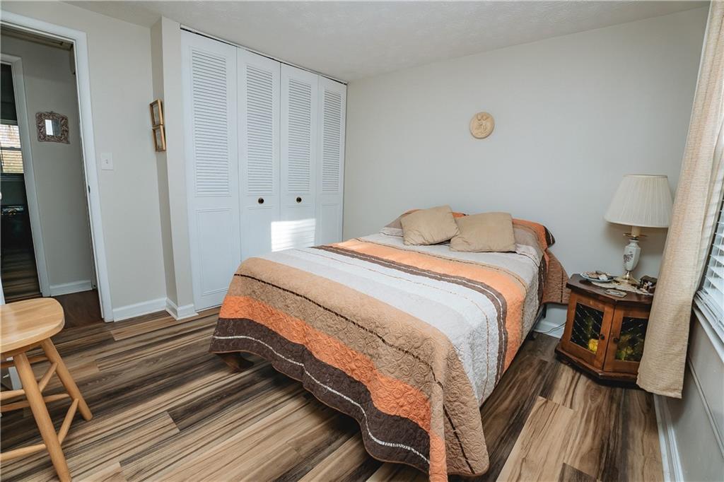 3184 Newcastle Way Snellville, GA 30039 - Photo 21 of 36 a bedroom with a bed and wooden floor