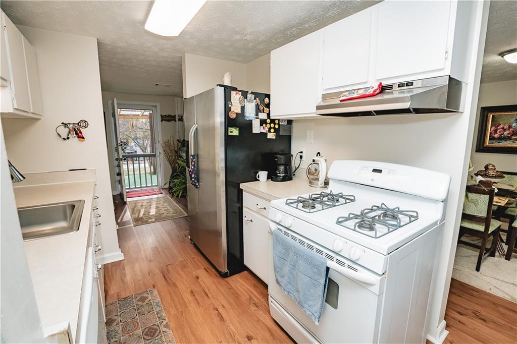 3184 Newcastle Way Snellville, GA 30039 - Photo 29 of 36 a kitchen with stainless steel appliances a stove a microwave and a refrigerator